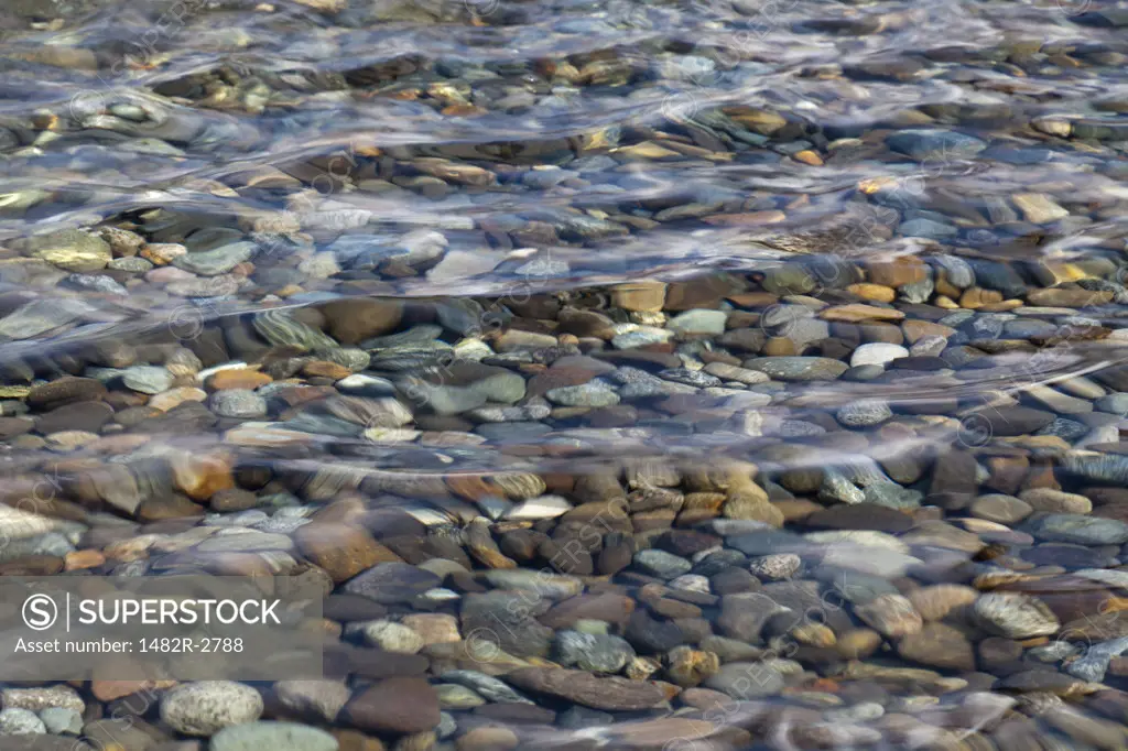Pebbles under water, high angle view
