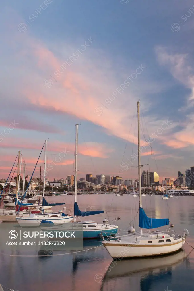 USA, California, San Diego, Sailboats in harbor at sunset