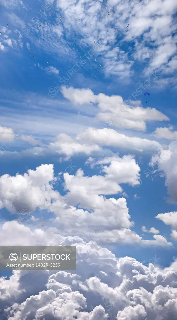 Blue sky, clouds, and Paraglider (digital composite)