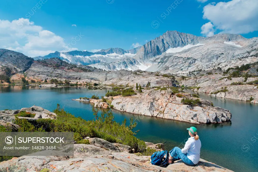Female hiker sitting on a rock, Shamrock Lake, Hoover Wilderness, Inyo National Forest, California, USA