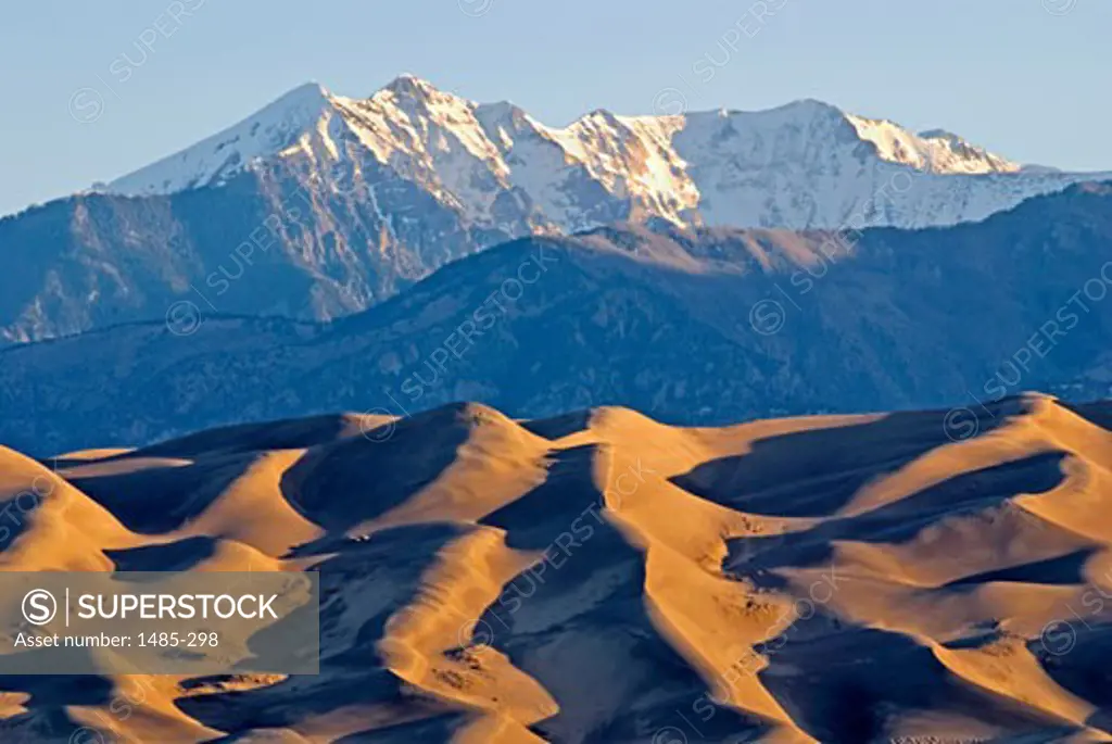 Rippled pattern on sand dune with mountains in the background, Great Sand Dunes National Park And Preserve, Colorado, USA