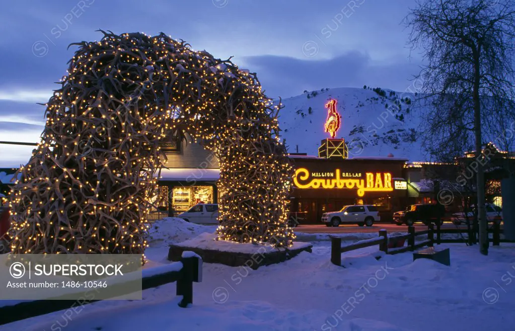 Decorated arch lit up at dusk, Elk Antler Arch, Jackson, Wyoming, USA