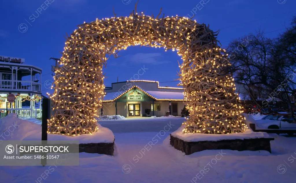 Decorated arch lit up at dusk, Elk Antler Arch, Jackson, Wyoming, USA