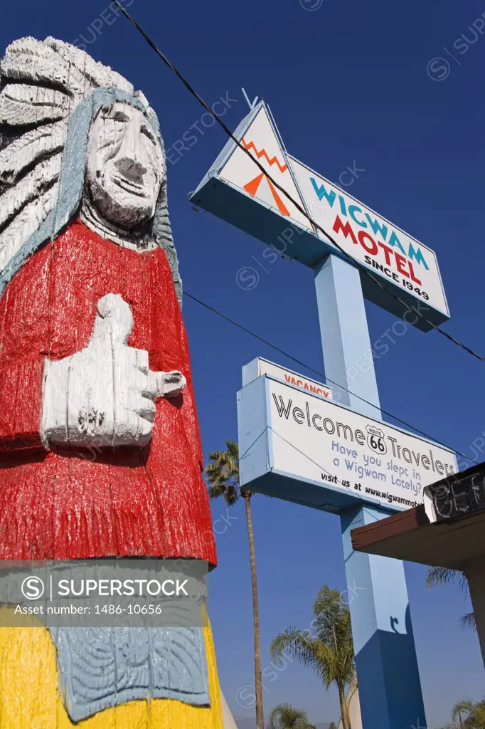 Low angle view of a wooden statue near a motel built in 1949, Wigwam Motel, Route 66, Rialto, California, USA