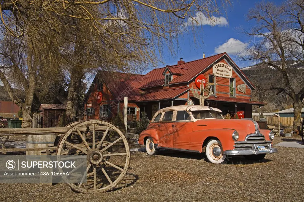 Vintage car in front of an antique shop, El Jebel, Aspen Region, Rocky Mountains, Colorado, USA