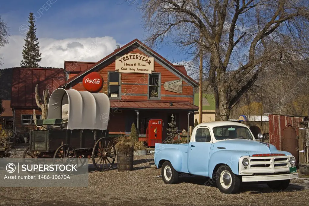 Vintage car in front of an antique shop, El Jebel, Aspen Region, Rocky Mountains, Colorado, USA