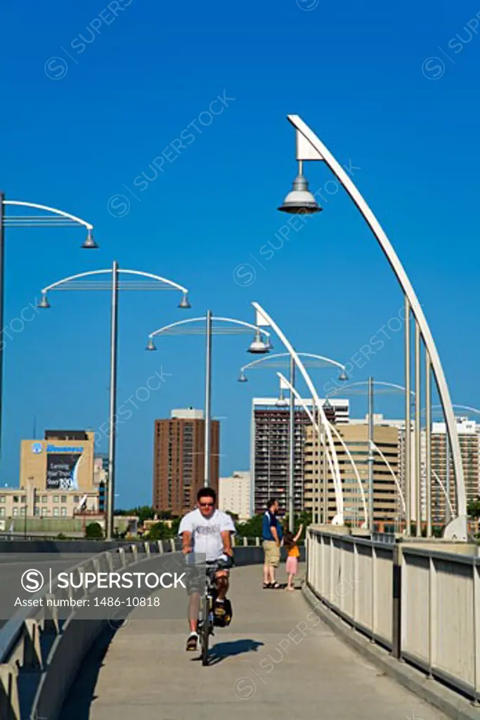 Man riding a bicycle on the bridge, Provencher Bridge, Winnipeg, Manitoba, Canada