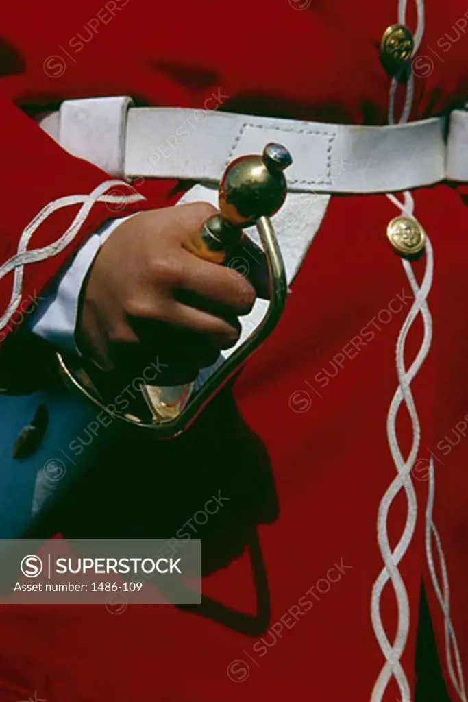 Royal guard in 18th century French soldier uniform holding a sword, Quebec City, Quebec, Canada