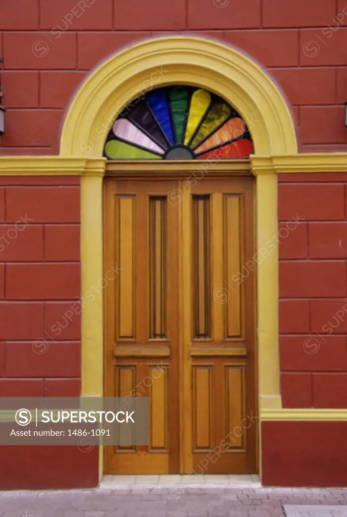 Colored glass arch above a door of a building, Mazatlan, Mexico