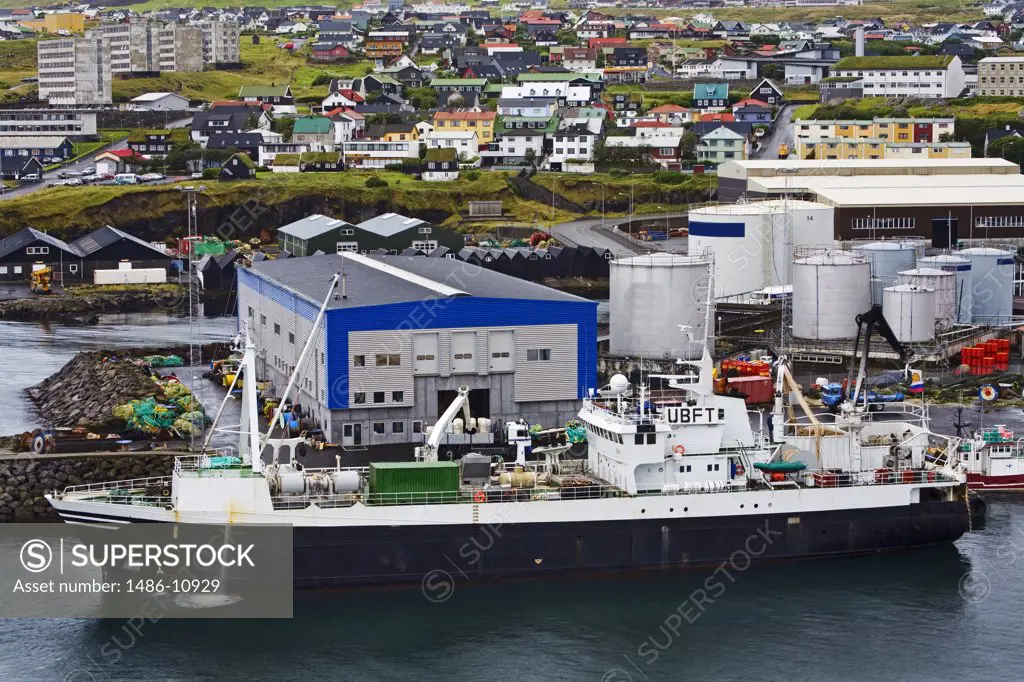 Ship at a dock with a town in the background, Tinganes, Torshavn, Faroe Islands, Denmark