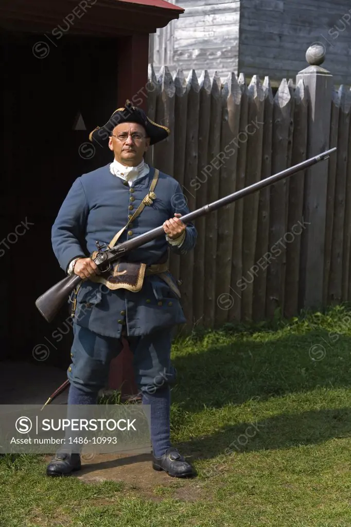 Portrait of a senior man standing and holding a rifle, King's Bastion, Fortress Of Louisbourg, Louisbourg, Cape Breton Island, Nova Scotia, Canada