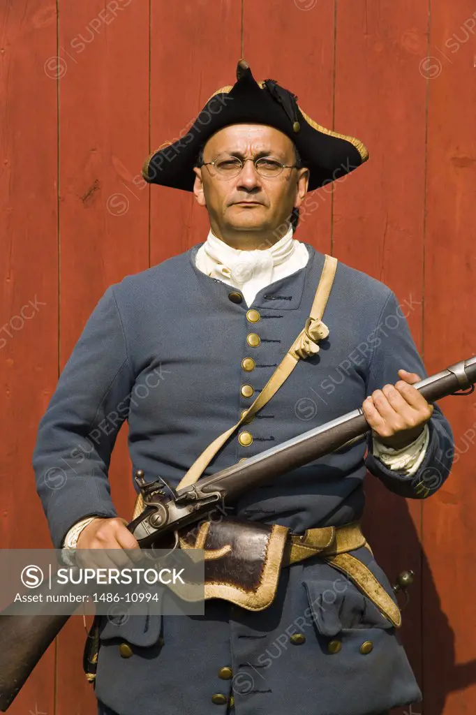 Portrait of a senior man standing and holding a rifle, Fortress of Louisbourg, Louisbourg, Cape Breton Island, Nova Scotia, Canada