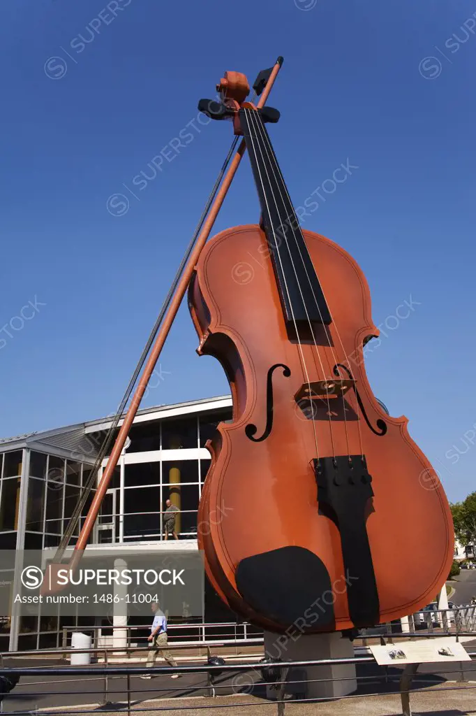 Low angle view of a sculpture of a giant fiddle, Big Ceilidh Fiddle by Cyril Hearn, Cruise Pavilion, Port of Sydney, Sydney, Cape Breton Island, Nova Scotia, Canada