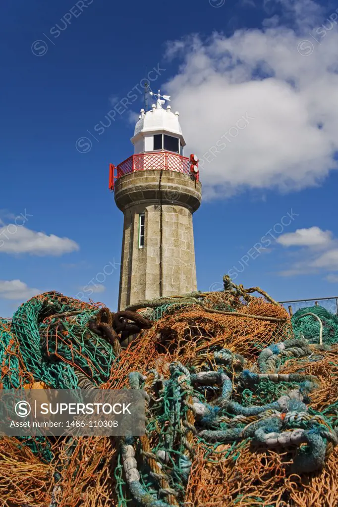 Fishing nets in front of a lighthouse, Dunmore East Lighthouse, Dunmore East, County Waterford, Munster Province, Ireland