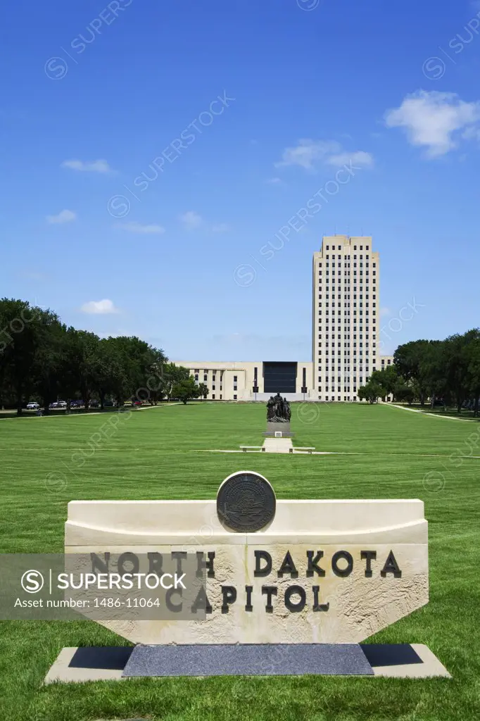 Information sign on a lawn with a building in the background, State Capitol Building, Bismarck, North Dakota, USA