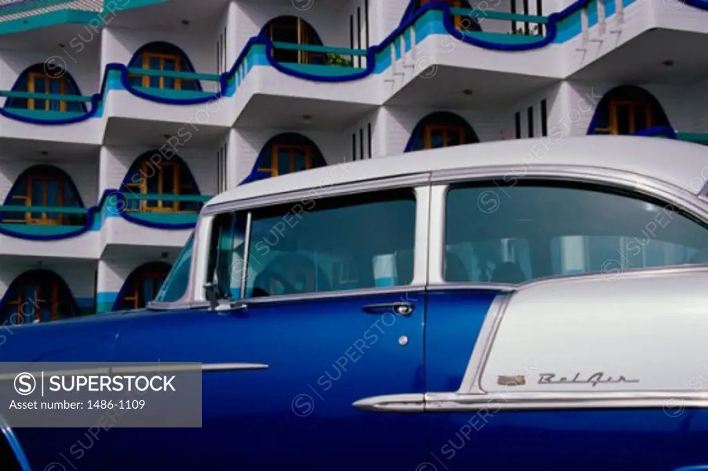 Side profile of a classic car parked in front of a hotel, Amigo Plaza Hotel, Mazatlan, Mexico