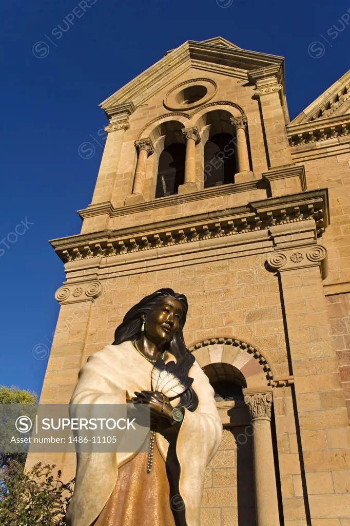 Low angle view of a statue of St. Kateri Tekakwitha in front of a cathedral, St. Francis Cathedral, Santa Fe, New Mexico, USA