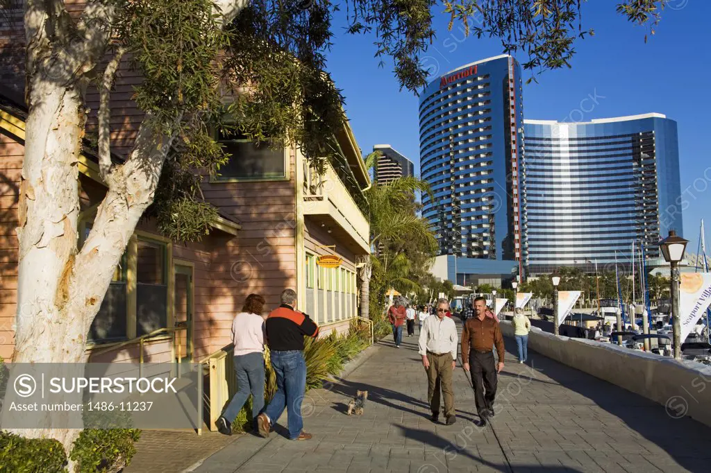 Tourists on a walkway with a hotel in the background, San Diego Marriott Hotel and Marina, Embarcadero Marina, San Diego, California, USA