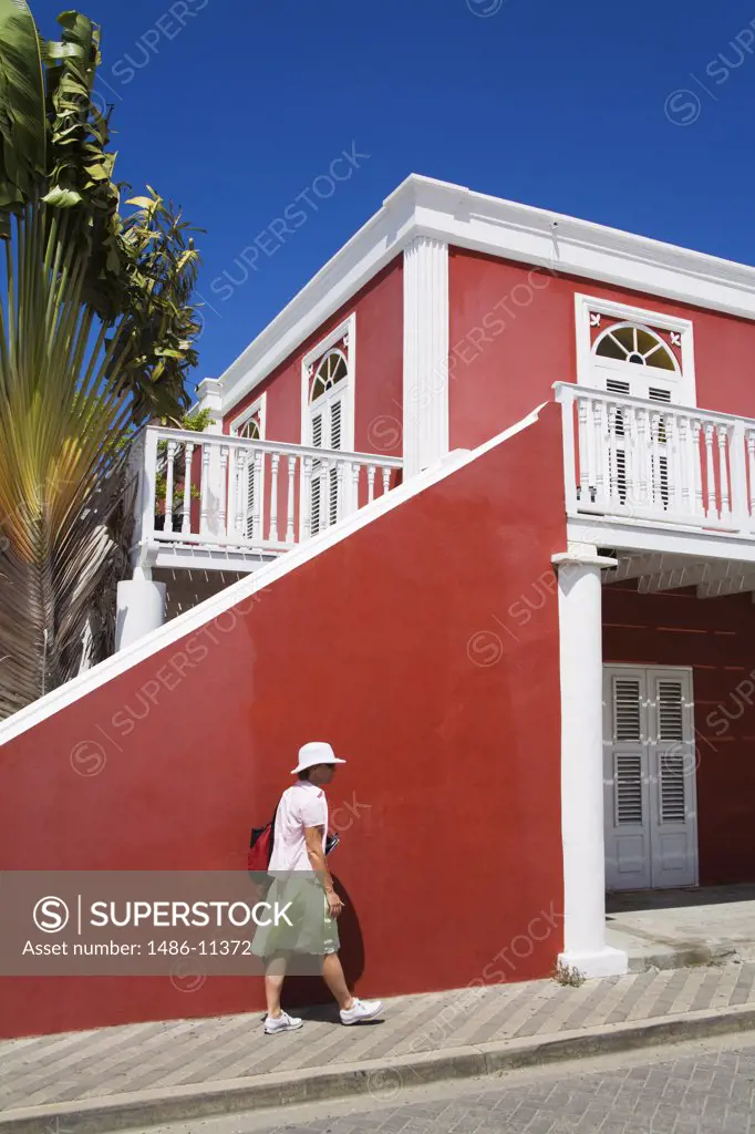 Woman walking on a sidewalk near a hotel, Hotel Columbia, Oranjestad, Aruba