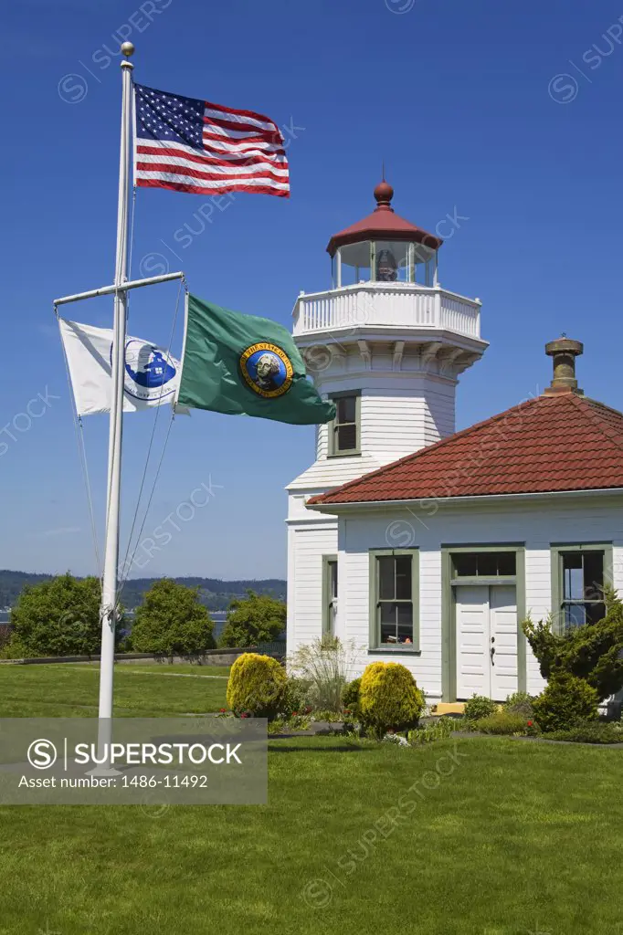 American flag fluttering in front of a lighthouse, Mukilteo Lighthouse, Mukilteo, Snohomish County, Seattle Metropolitan Area, King County, Washington State, USA