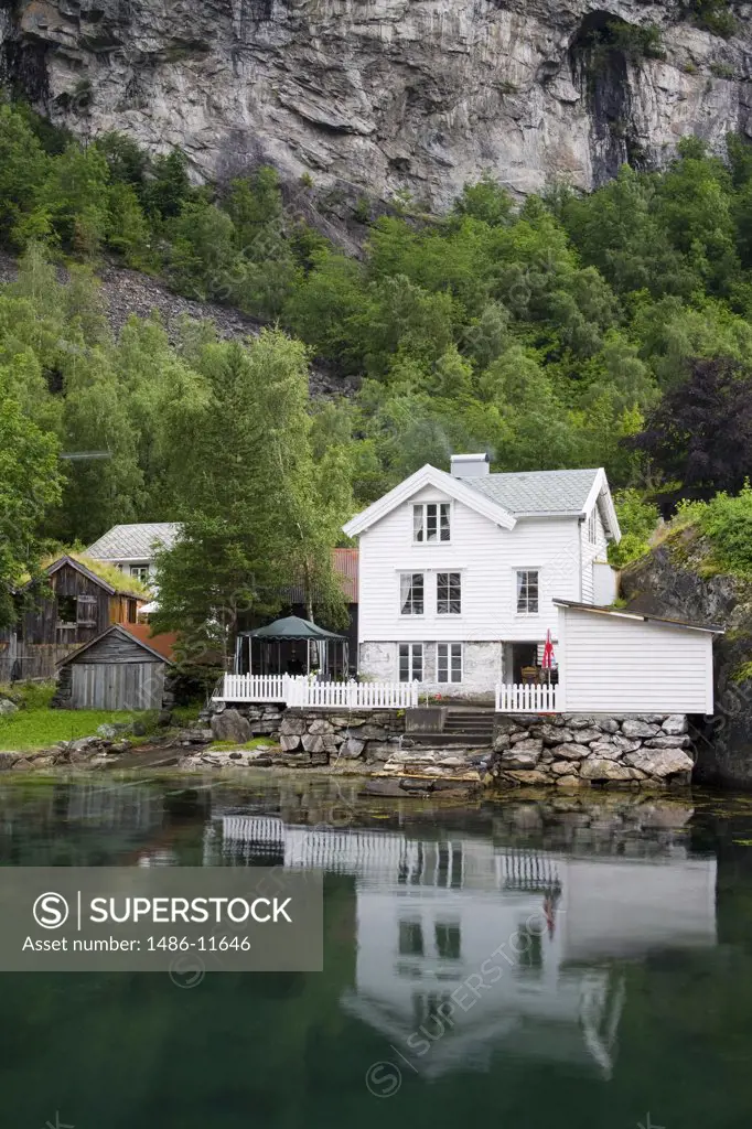 Reflection of a building in water, Geiranger, Geirangerfjord, More og Romsdal, Sunnmore, Norway