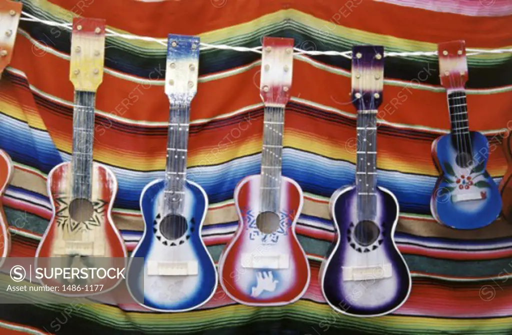 Close-up of guitars hanging in a row, Cabo San Lucas, Mexico