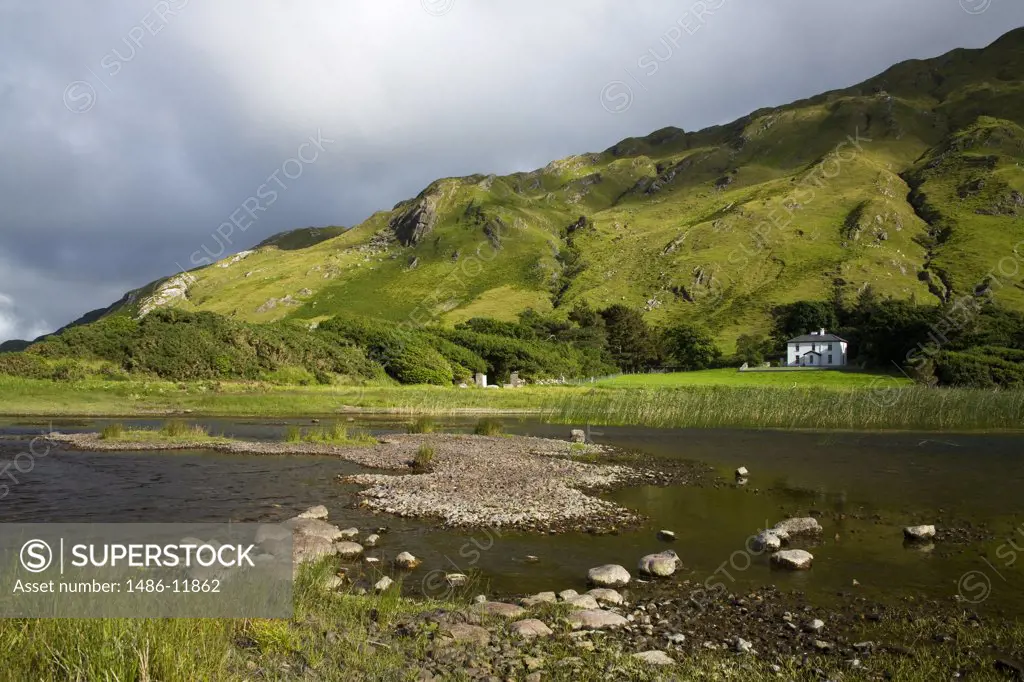 Lake with a hotel and a hill in the background, Lake Kylemore, Connemara, County Galway, Connacht Province, Republic of Ireland
