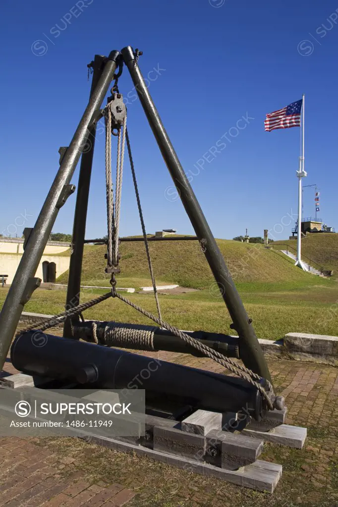 Cannon at a fort with American flag fluttering in the background, Fort Moultrie, Sullivans Island, Charleston, South Carolina, USA