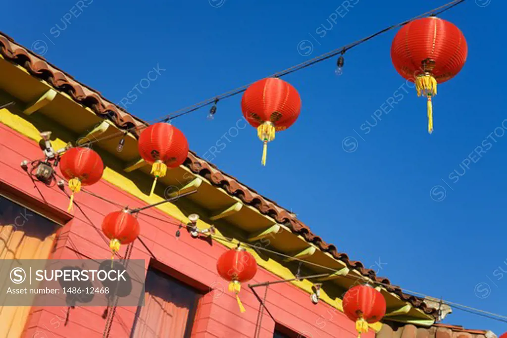 Low angle view of lanterns hanging in front of a building, Chinatown, Los Angeles, California, USA