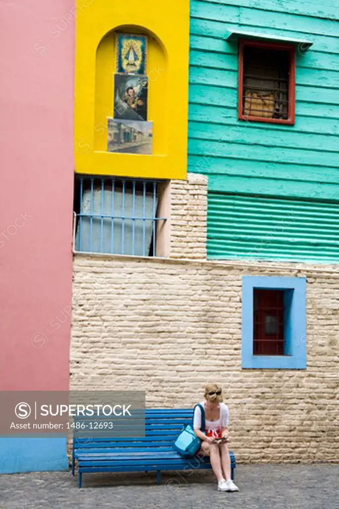 Woman sitting on a bench, Caminito, La Boca, Buenos Aires, Argentina