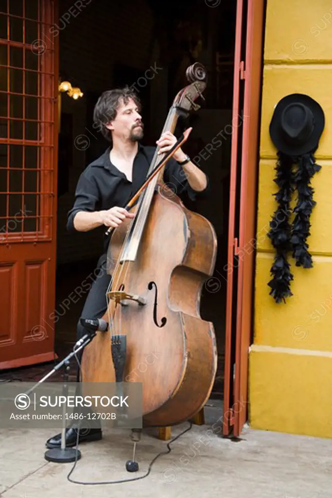 Man playing a guitar in a doorway, Caminito, La Boca, Buenos Aires, Argentina