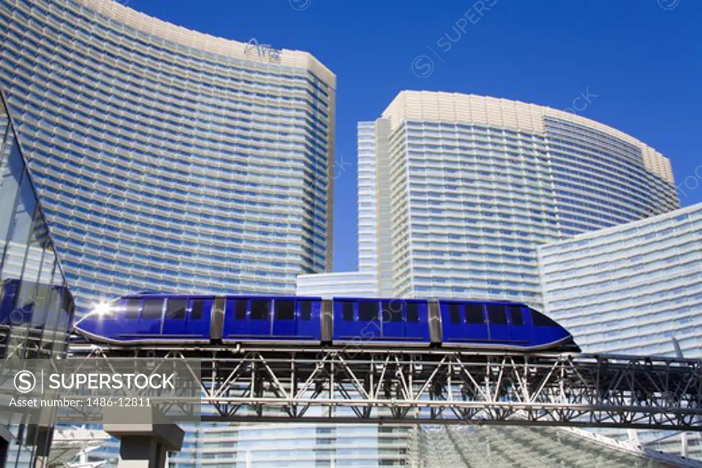 Monorail on a bridge with a hotel in the background, Aria Resort And Casino, The Strip, Las Vegas, Nevada, USA