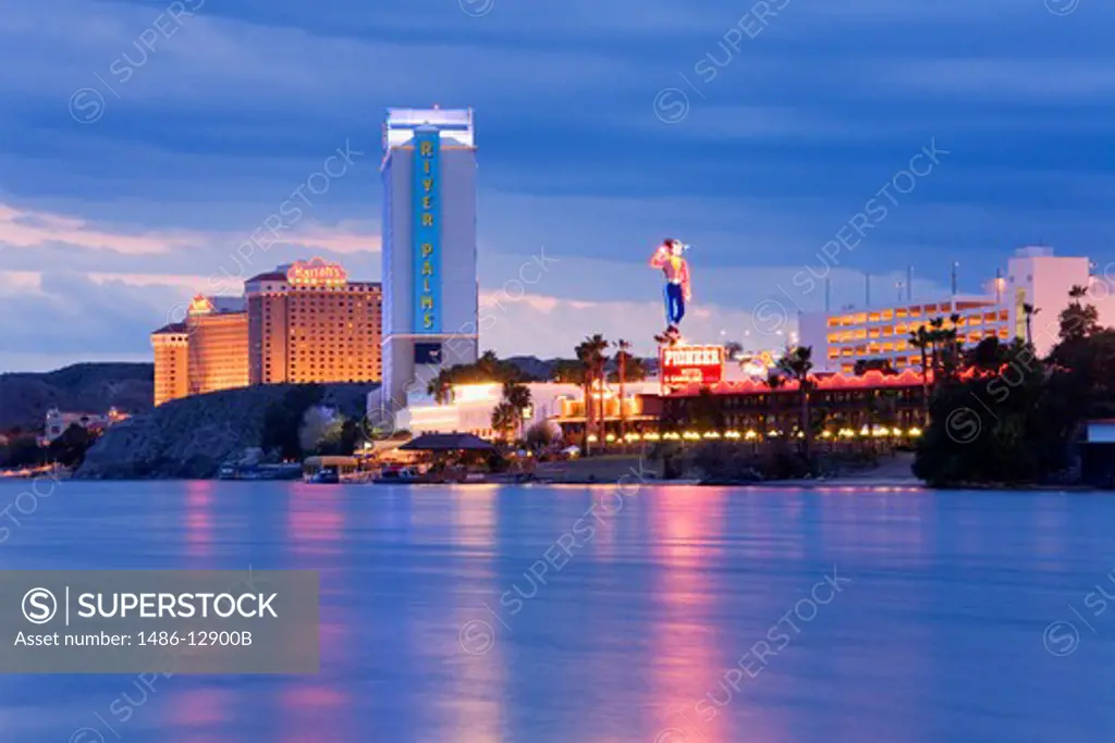 USA, Nevada, Laughlin City, River Palms & Harrah's Casinos on Colorado River at dusk