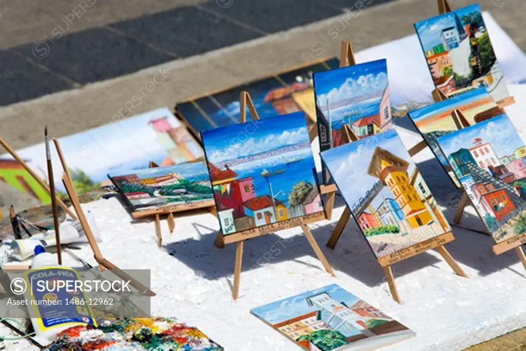 Paintings for sale at a market stall, Muelle Prat, Plaza Sotomayor, Valparaiso, Chile