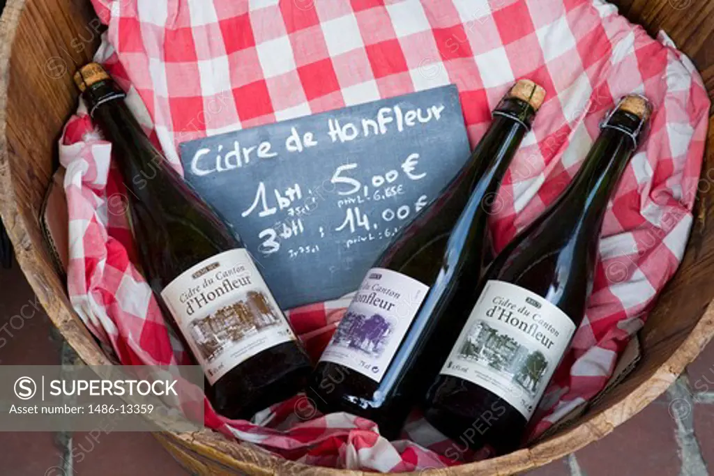 Wine bottles in a basket, Honfleur, Calvados, Basse-Normandy, France