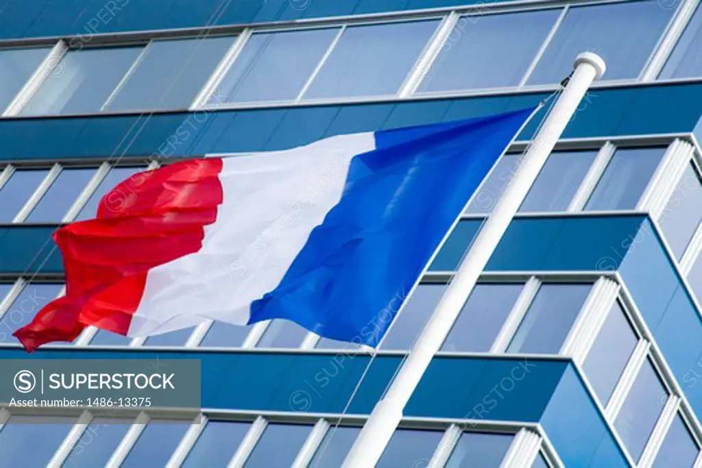 Low angle view of a French flag in front of an office building, Le Havre, Seine-Maritime, Haute-Normandy, France