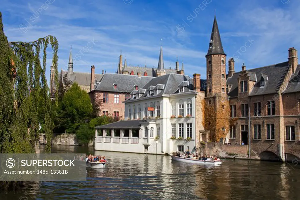 Tourboat in a canal, Huidenvetters Square, Bruges, Belgium