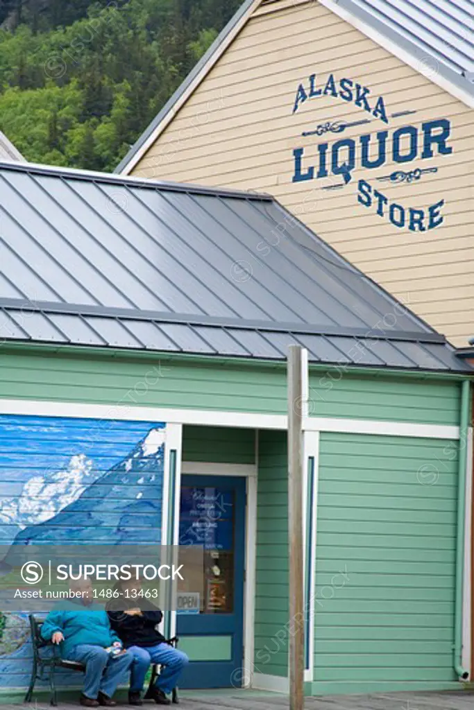 People sitting in front of a liquor store, Alaska Liquor Store, 2nd Avenue, Skagway, Alaska, USA