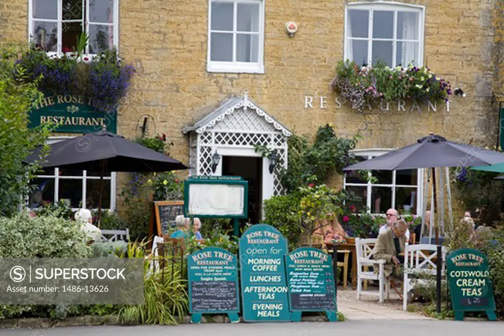 Tourists at a restaurant, Bourton-On-The-Water, Cotswold, Gloucestershire, England