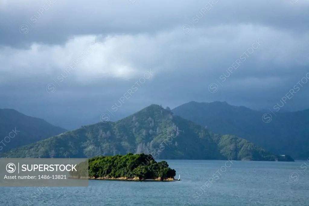 Island with mountains under cloudy sky, Queen Charlotte Sound, Picton, Marlborough, South Island, New Zealand
