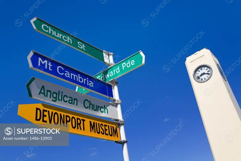 Low angle view of road signs and Watson Memorial, Devonport, Auckland, North Island, New Zealand