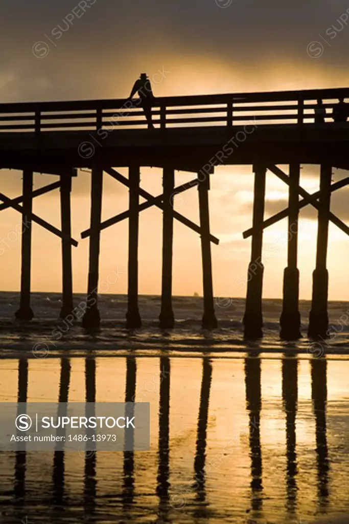 Silhouette of a person standing on the pier, Newport Beach, Orange County, California, USA