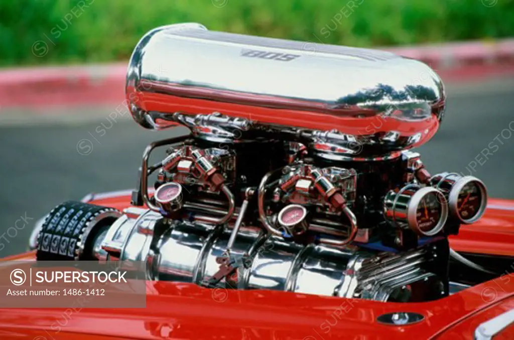 Engine block head sticking out of the hood of a 1959 Chevrolet Corvette