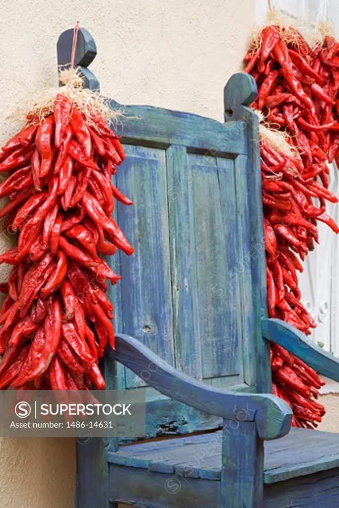 USA,New Mexico, Albuquerque, Old Town District, Antique chair and chili peppers
