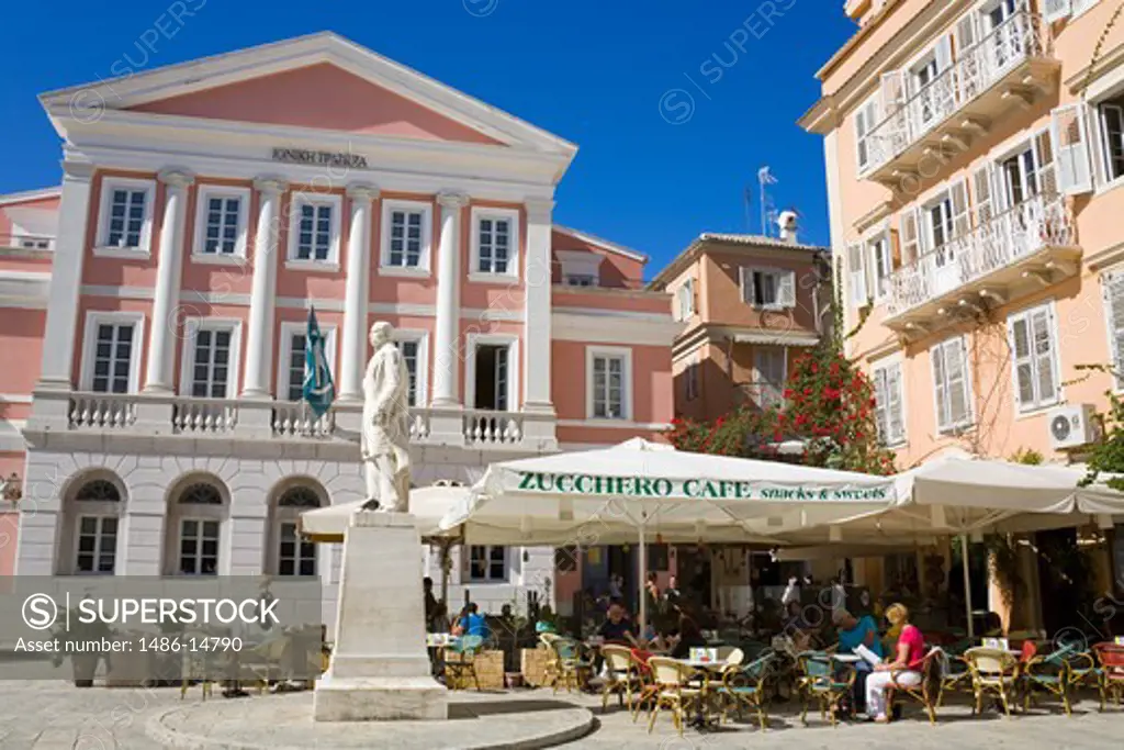 Tourists at a cafe with Banknote Museum in the background, Heroes of Cypriot Struggle Square, Corfu Town, Ionian Islands, Greece