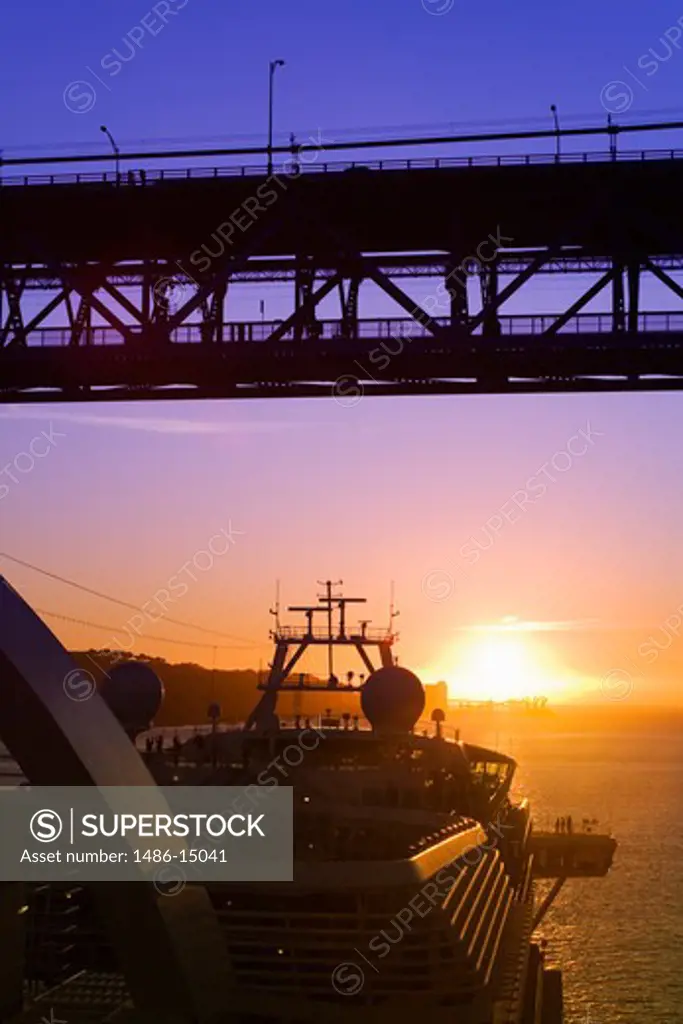 Cruise ship passing under the 25th of April Bridge, Tejo (Tagus) River, Lisbon, Portugal, Europe