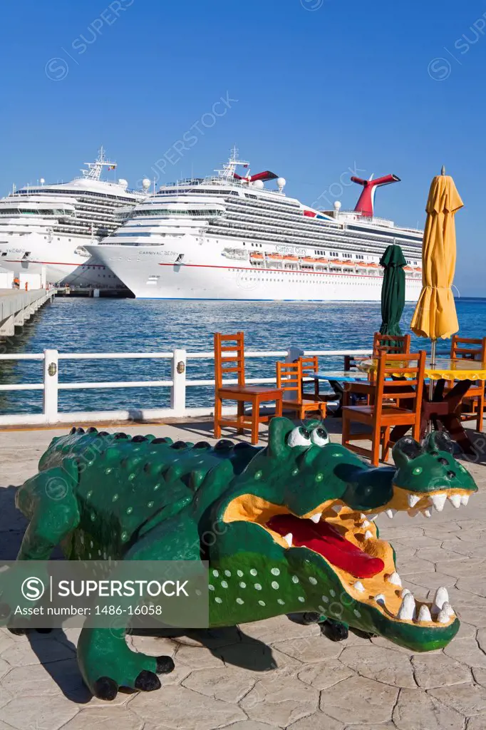 Alligator's statue with cruise ships in the background, Puerta Maya, Cozumel, Quintana Roo, Yucatan Peninsula, Mexico