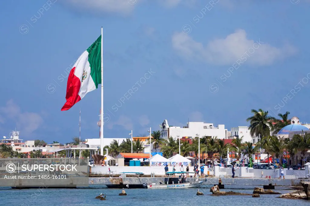 Mexican flag fluttering at waterfront, San Miguel, Cozumel, Quintana Roo, Yucatan Peninsula, Mexico