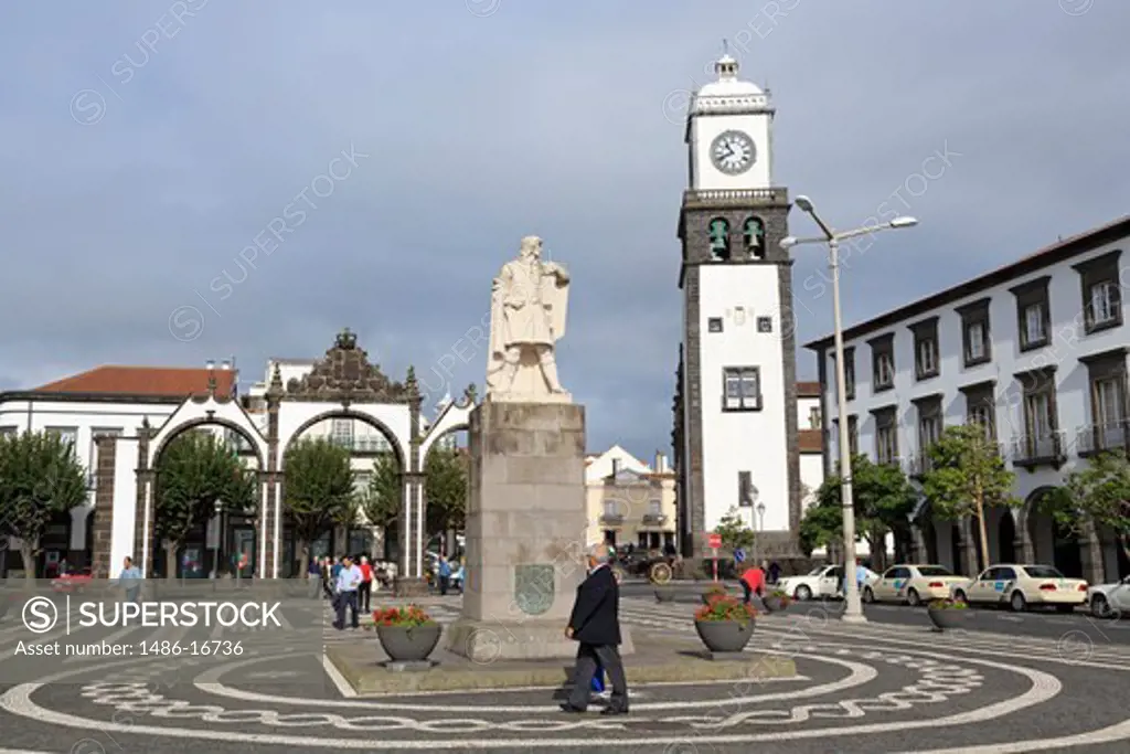 Statue of Goncalo Velho Cabral with clock tower of St. Sebastian Church at Ponta Delgada, Sao Miguel, Azores, Portugal