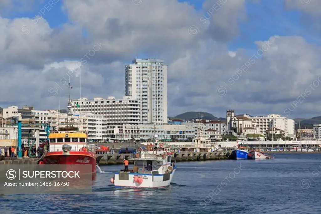 Fishing boats at a harbor with city in the background, Ponta Delgada, Sao Miguel, Azores, Portugal